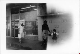 Hiemstra family outside the laundry and dry cleaning shop, [196-] thumbnail