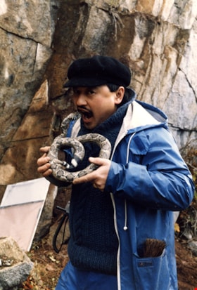 Jimmy Chow holding a prop snake, [1987] thumbnail