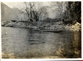 Man paddling a canoe on a lake, [190-] thumbnail