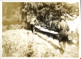 Two men carrying long plank of wood with food, [1919] thumbnail