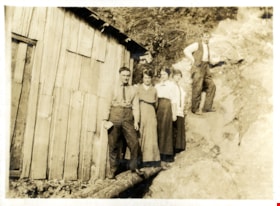 Five people standing outside of clapboard building, [c. 1915] thumbnail