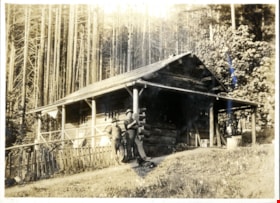Two men outside log cabin, [191-] thumbnail