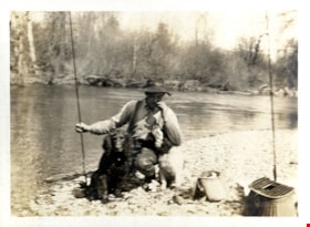 Henry Love fishing with dog, [191-] thumbnail