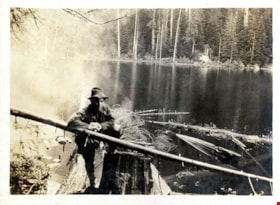 Man standing on log, [191-] thumbnail