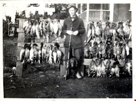Bob Love with dead fowl in front of Whiting family home, [191-] thumbnail