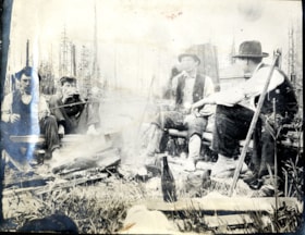 Four men around campfire, [191-] thumbnail
