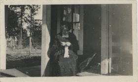 Woman knitting on porch, [191-] thumbnail
