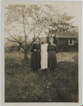 Three girls standing under cherry tree, [191-] thumbnail