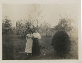 Esther Love Stanley and woman in garden with fruit trees, [191-] thumbnail