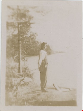 Woman standing on shore, [191-] thumbnail