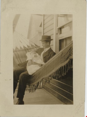 Man in hammock holding baby, [191-] thumbnail