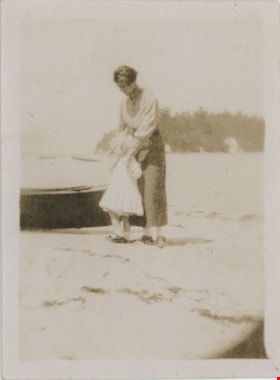 Woman and child on beach, [191-] thumbnail