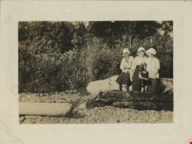 Three women and child on beach, [192-] thumbnail