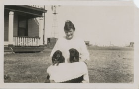 Woman holding two puppies, [1930] thumbnail