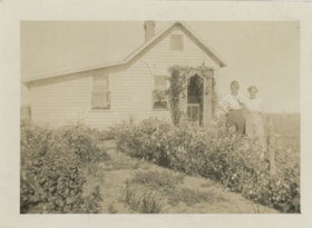 Two women standing in garden, [193-] thumbnail