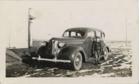 Boy standing next to automobile, [194-] thumbnail