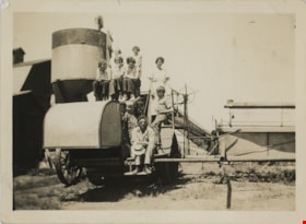 Group posing on farming machinery, [193-] thumbnail