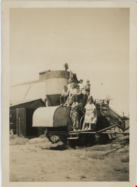 Group posing on farming machinery, [193-] thumbnail