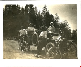 Seven people on road with automobile and bikes, [191-] thumbnail