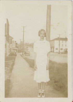 Girl standing on sidewalk, [192-] thumbnail