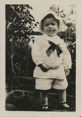 Young child standing in garden, [192-] thumbnail