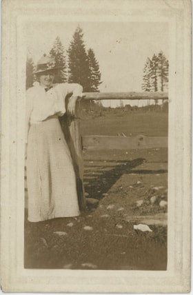 Woman leaning on fence, [191-] thumbnail