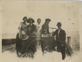 Women and child inside wooden cart, [191-] thumbnail