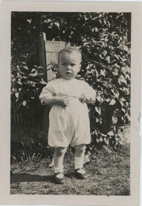 Young child standing in garden, [191-] thumbnail