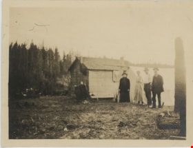 Four people standing next to cabin, [191-] thumbnail