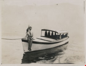 Man seated on bow of boat, [191-] thumbnail