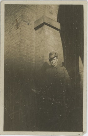 Man in uniform in front of brick building, [191-] thumbnail