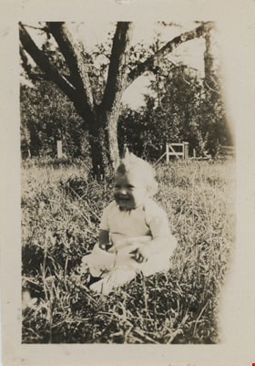 Stanley baby seated in tall grass under tree, [192-] thumbnail