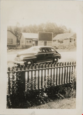 Automobile on residential street, [194-] thumbnail