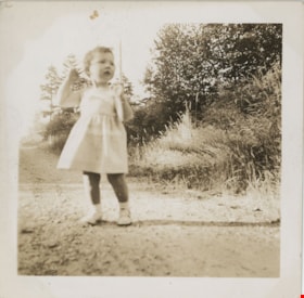 Young child standing on dirt road, [194-] thumbnail