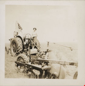 Woman on tractor, [194-] thumbnail