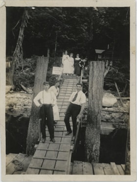 Men and women on wooden walkway of landing, [192-] thumbnail