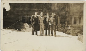 Four men standing in snow, [193-] thumbnail
