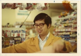 Harry Toy at cash register inside Canada Way Food Market, [May 1972] thumbnail